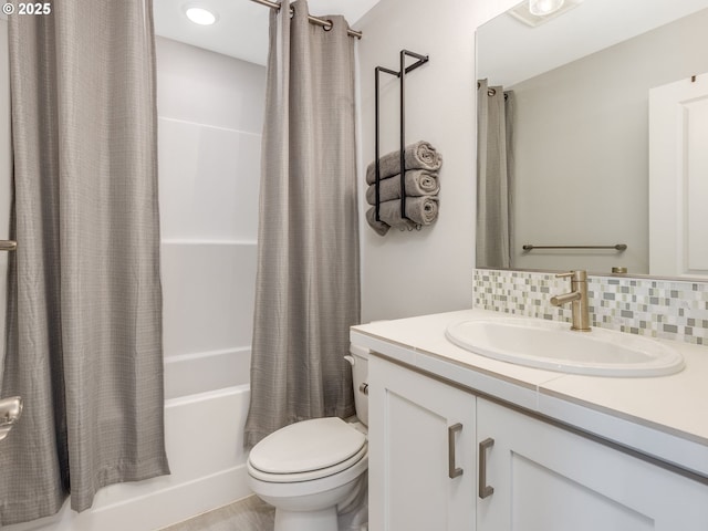 full bathroom featuring toilet, shower / bath combination with curtain, backsplash, and vanity