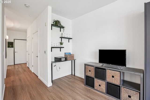 1125 NW 9th Ave Unit 427, Portland, OR 97209 - unfurnished living room with wood finished floors and baseboards