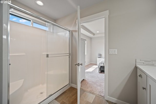 1012 NE 11th Ct, Battle Ground, WA 98604 - full bathroom featuring wood finished floors, a shower stall, vanity, and recessed lighting