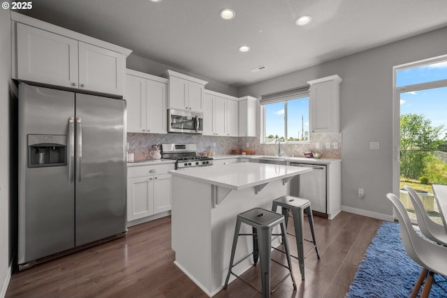 1012 NE 11th Ct, Battle Ground, WA 98604 - kitchen with stainless steel appliances, recessed lighting, white cabinetry, a center island, and decorative backsplash