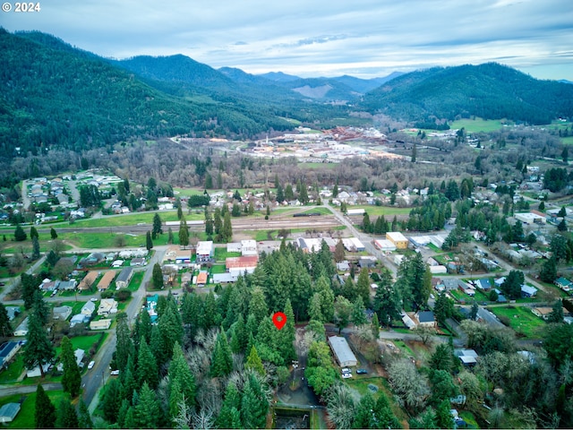drone / aerial view featuring a residential view and a mountain view