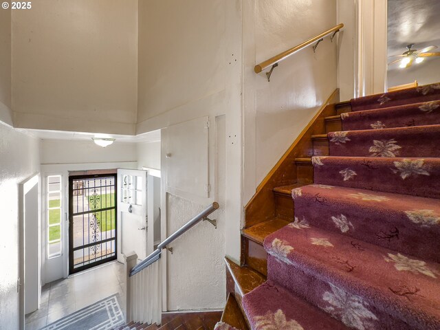 217 N Main St, Halfway, OR 97834 - staircase with a towering ceiling, a ceiling fan, and tile patterned flooring