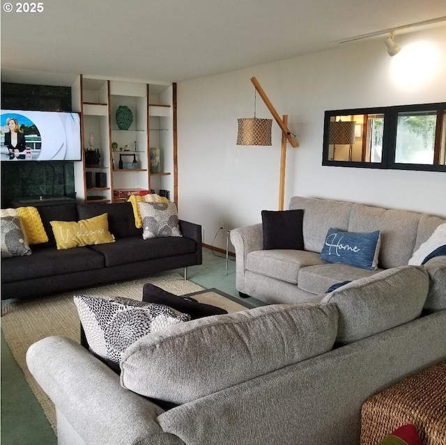 carpeted living room featuring rail lighting