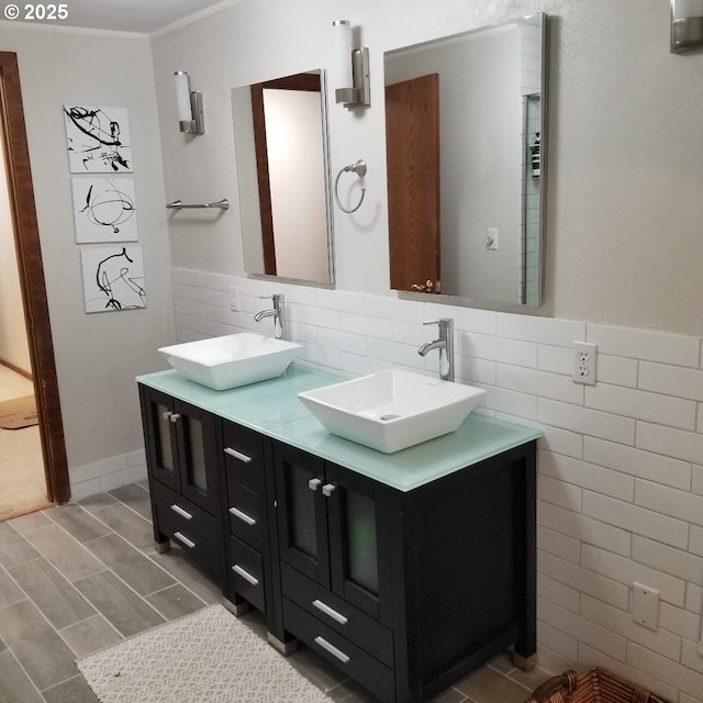 bathroom featuring ornamental molding, vanity, and tile walls