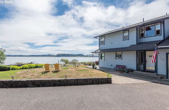 exterior space with a patio area and a water view