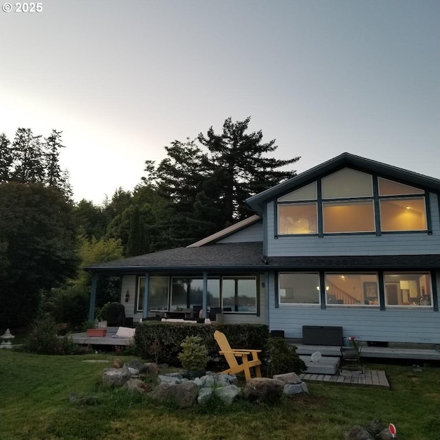 rear view of house featuring a yard and a patio area