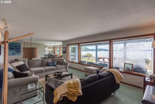 carpeted living room featuring a water view