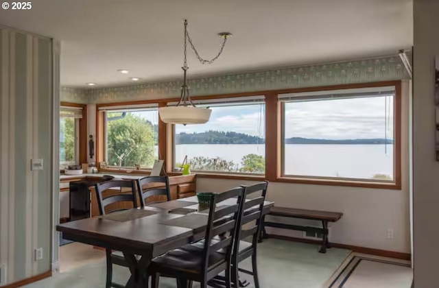 dining room featuring a water view