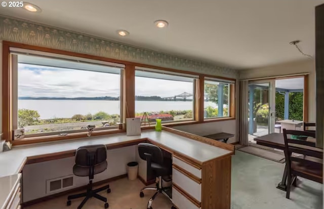 home office with a water view and built in desk