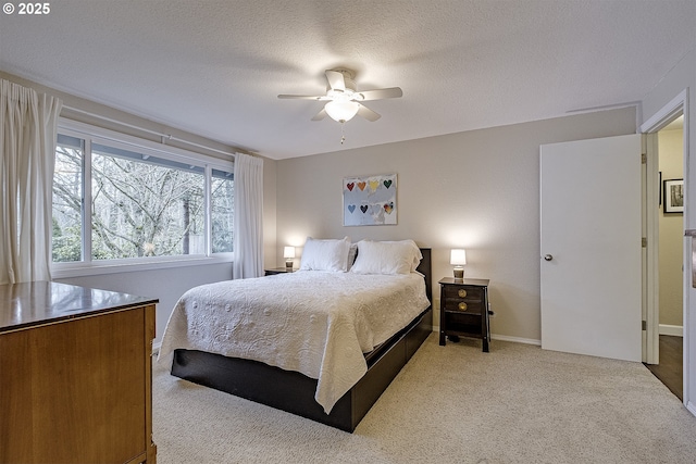 bedroom featuring baseboards, carpet flooring, a textured ceiling, and a ceiling fan