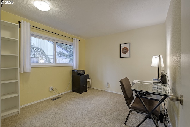 office featuring visible vents, baseboards, carpet, and a textured ceiling