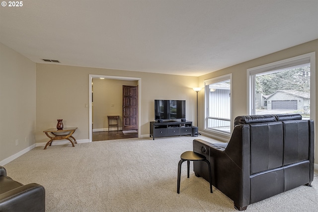 carpeted living room featuring visible vents and baseboards