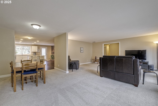 interior space featuring baseboards and light carpet