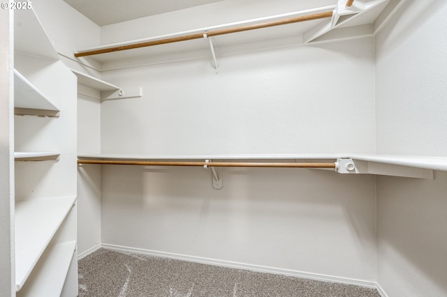 spacious closet featuring carpet floors and built in desk