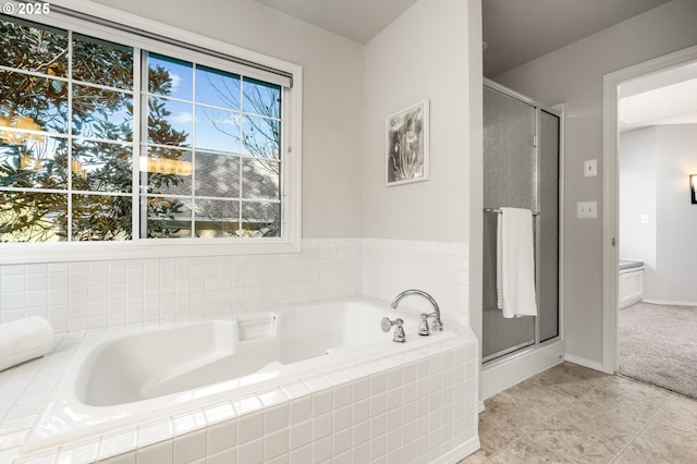 bathroom with tile patterned flooring and plus walk in shower