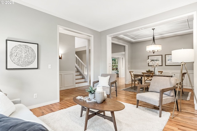 living room featuring light hardwood / wood-style flooring and ornamental molding