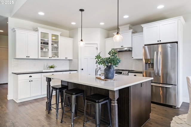 31870 SE Grace St, Gresham, OR 97080 - kitchen featuring stainless steel fridge with ice dispenser, under cabinet range hood, dark wood-style flooring, tasteful backsplash, and white cabinets
