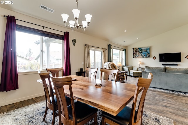 654 Wilson Ave, Cottage Grove, OR 97424 - dining space featuring an inviting chandelier, wood finished floors, visible vents, baseboards, and vaulted ceiling