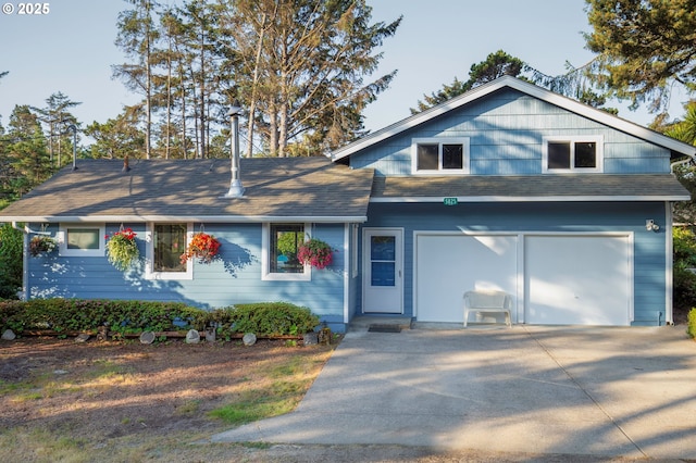 5825 Roma Ave, Cloverdale, OR 97112 - view of front facade with roof with shingles, driveway, and an attached garage