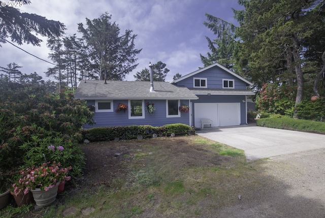 5825 Roma Ave, Cloverdale, OR 97112 - view of front of house featuring a garage, concrete driveway, and roof with shingles