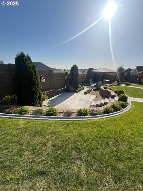 101 Rome St, Boardman, OR 97818 - view of yard featuring a gazebo, a fenced backyard, and a patio area