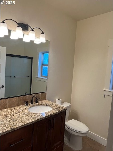 101 Rome St, Boardman, OR 97818 - bathroom featuring toilet, tile patterned floors, baseboards, and vanity
