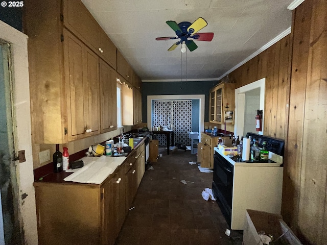 kitchen with washer / clothes dryer, brown cabinetry, crown molding, stove, and ceiling fan