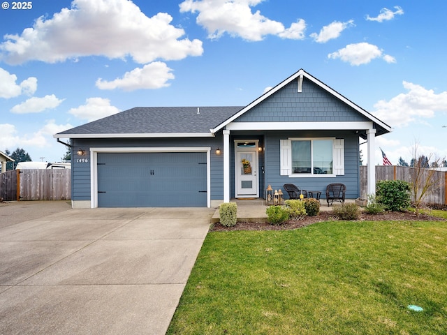 view of front of property with a garage, a porch, and a front lawn