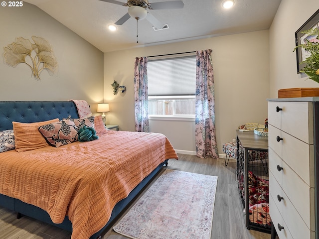 bedroom with lofted ceiling, ceiling fan, and light hardwood / wood-style flooring