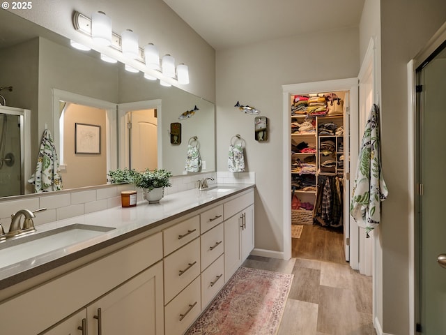 bathroom with vanity, hardwood / wood-style floors, and walk in shower