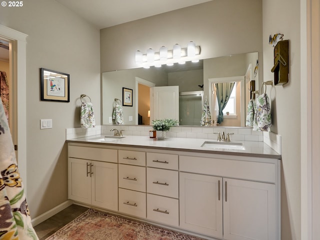 bathroom featuring vanity and a shower with shower door