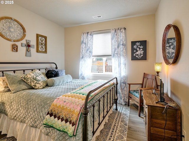 bedroom with hardwood / wood-style flooring