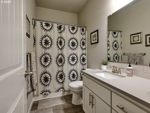 full bathroom featuring toilet, tasteful backsplash, vanity, shower / bath combo with shower curtain, and hardwood / wood-style floors