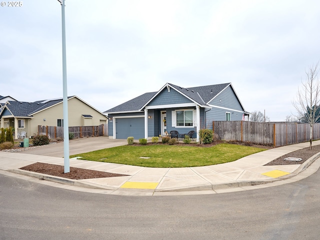 view of front of property with a garage and a front lawn