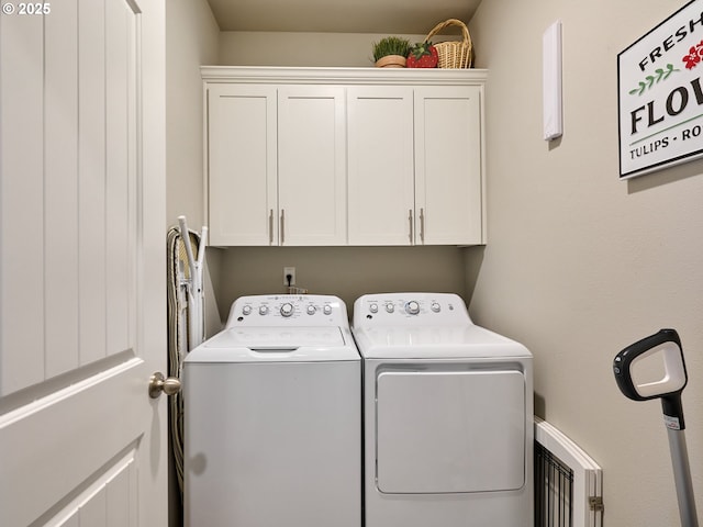 washroom with cabinets and separate washer and dryer