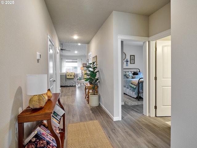 hallway with light hardwood / wood-style floors