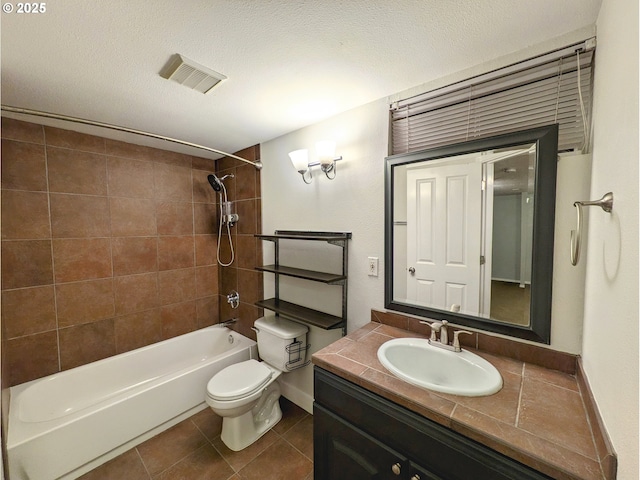 full bath featuring tile patterned floors, toilet,  shower combination, and a textured ceiling