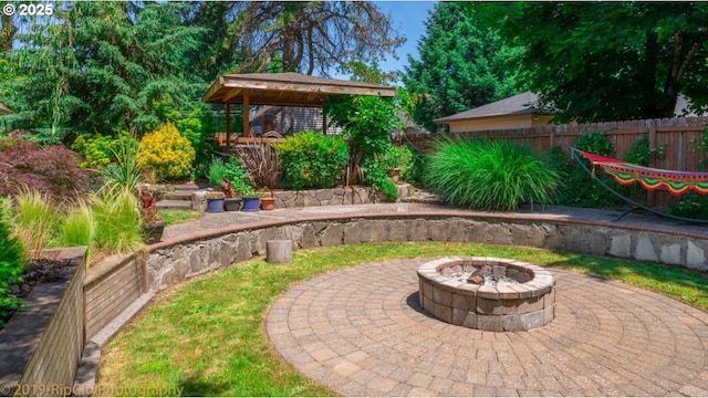 view of patio / terrace with a fire pit and fence