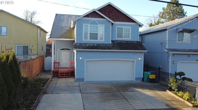 view of front of home featuring fence, a garage, driveway, and roof with shingles