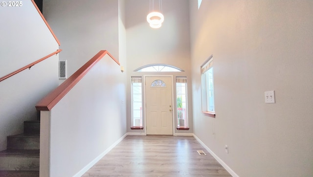 entryway featuring light wood finished floors, visible vents, and baseboards