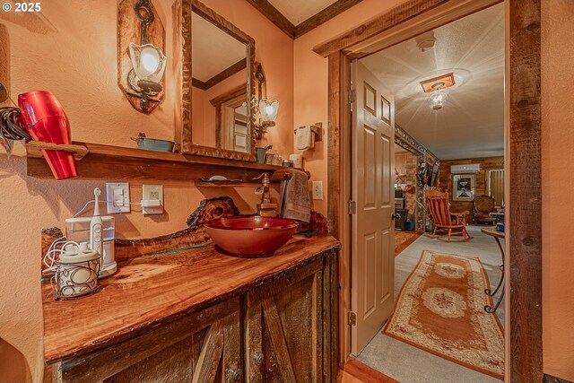 hallway with ornamental molding and sink