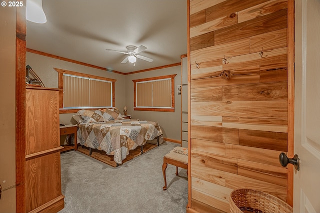 carpeted bedroom with crown molding and ceiling fan