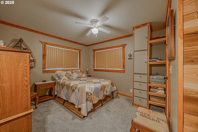 carpeted bedroom with crown molding and ceiling fan