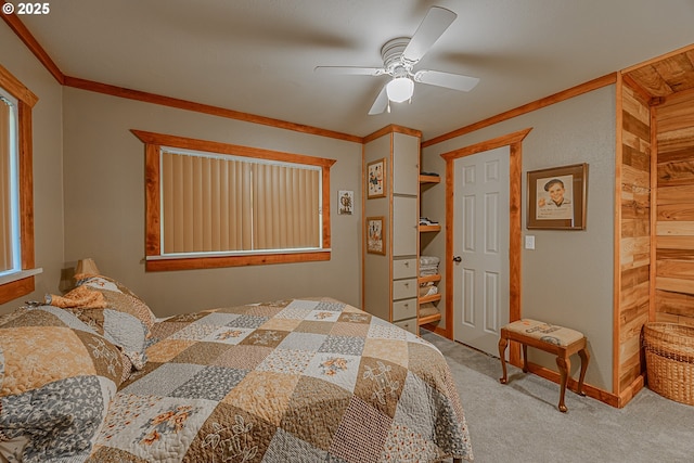 bedroom with crown molding, light colored carpet, and ceiling fan