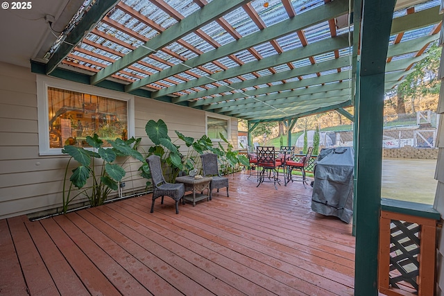 wooden deck featuring grilling area and a pergola