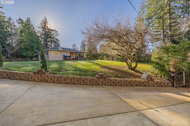 view of front of house with a patio and a front lawn