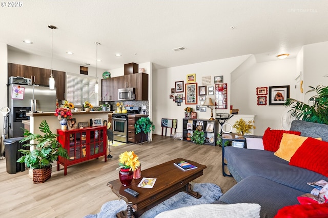 7869 NE Rockne Way, Hillsboro, OR 97006 - living room with light wood-style floors and recessed lighting