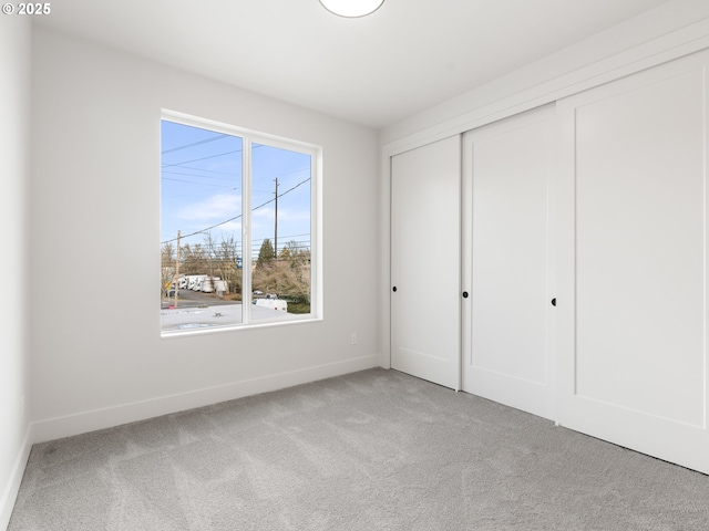 unfurnished bedroom with carpet floors and a closet