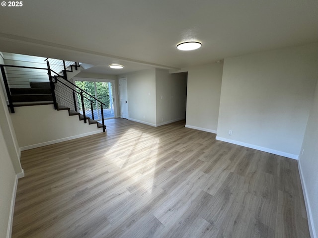 interior space with stairway, baseboards, and wood finished floors