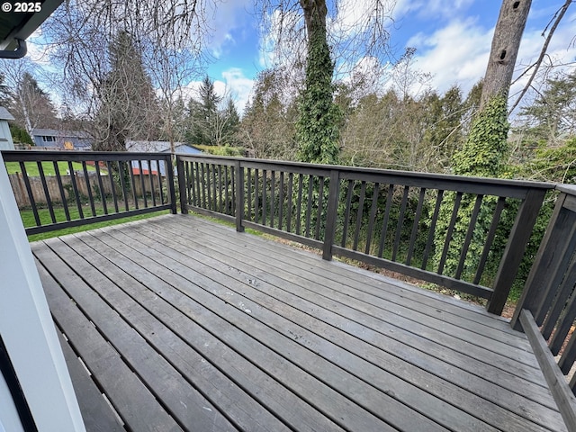 wooden terrace featuring fence